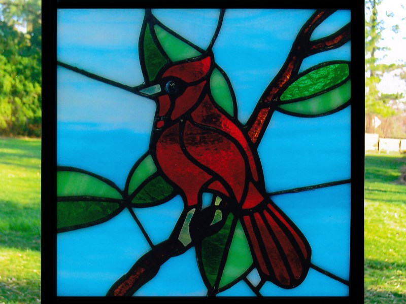 A Cardinal bird on a leafy branch that I made out of stained glass.